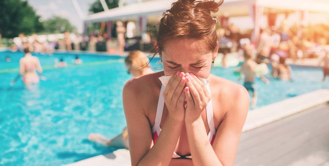 Women has runny nose in the summer on vacation.