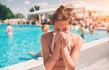 Women has runny nose in the summer on vacation.