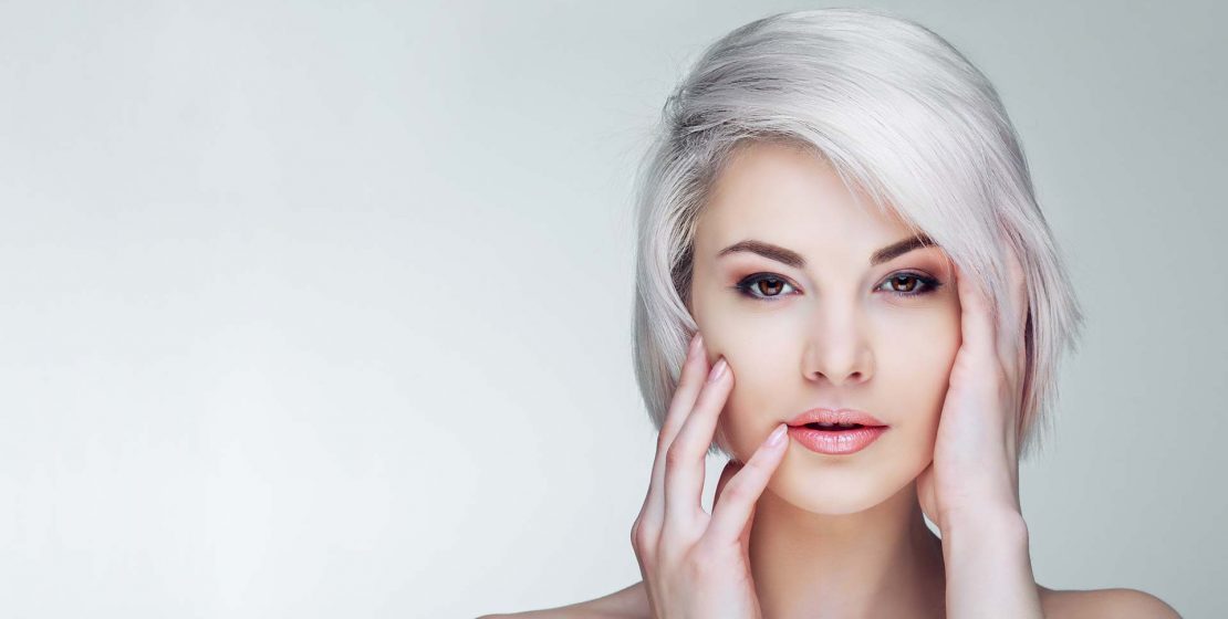 Woman with short platinum blond hair.