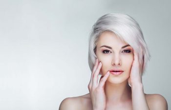 Woman with short platinum blond hair.