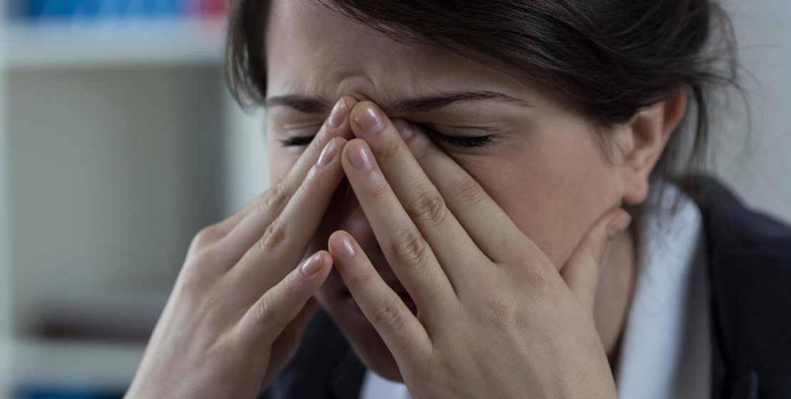 Young woman with sinus pressure pain.