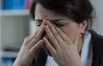 Young woman with sinus pressure pain.