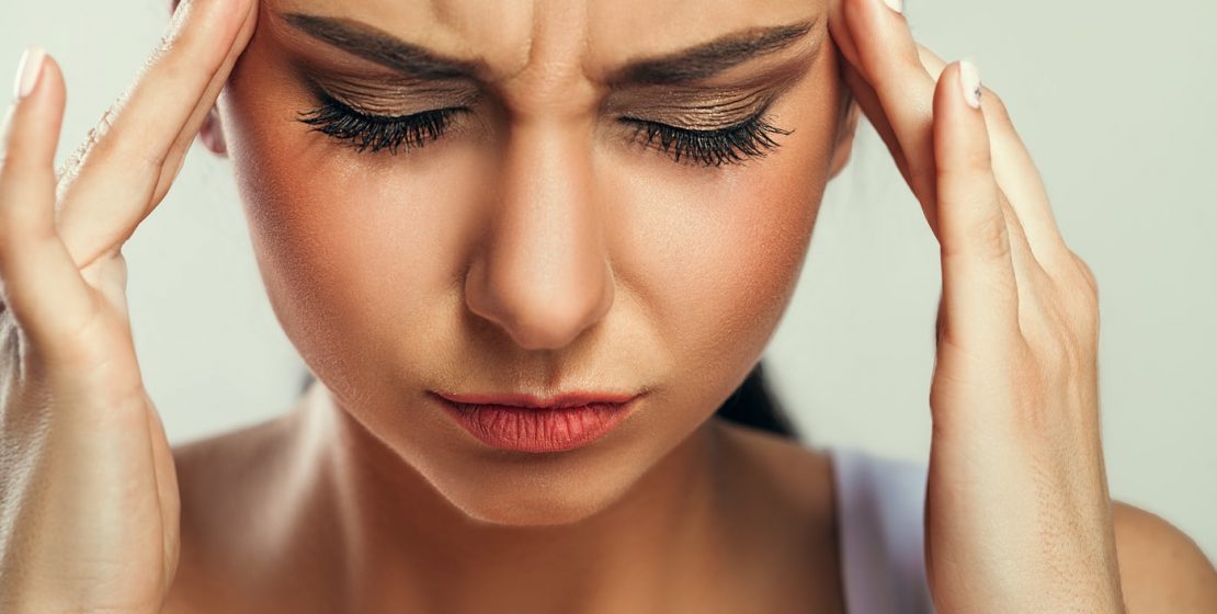 Young woman with headache.