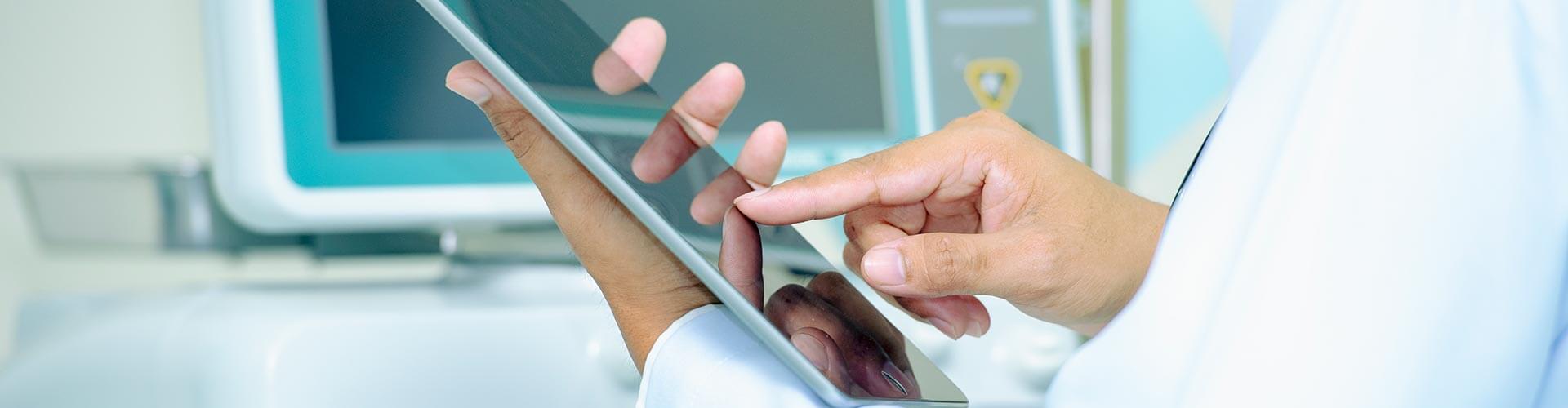 A doctor holding a tablet