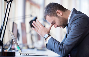 young man stressed at work