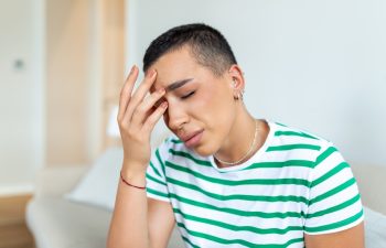 Sinus ache causing very paintful headache. Unhealthy woman in pain. Sharp strong sore. Sinus pain, sinus pressure, sinusitis. Sad woman holding her head because sinus pain