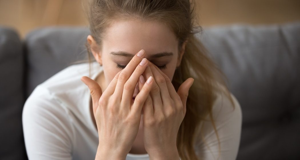 Close up thoughtful woman with closed eyes covered face in hands, feeling pain, having problem with relationships or health, headache, upset tired girl worried about future, making hard decision